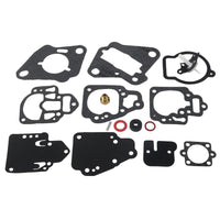photo of jlm marine carburetor repair kit for mercury mercruiser 6-25 hp 1395-97611 with paper and rubber gaskets in black and dark gray shades, featuring various cutouts, hole patterns, a red circular gasket, a coiled spring, a brass jet, and a white plastic needle assembly