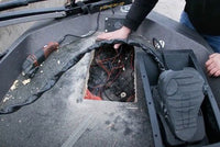 trolling motor tray rectangular opening with red and black wires entangled inside, black fabric sleeve, black plastic casing, gray futuristic device with indentations