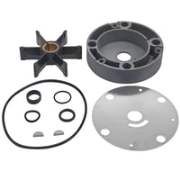 photo of JLM Marine water pump repair kit for OMC stringer drives 983218, featuring a six-bladed black rubber impeller with brass hub, grey plastic housing, O-rings, seals, keys, and a metal base plate